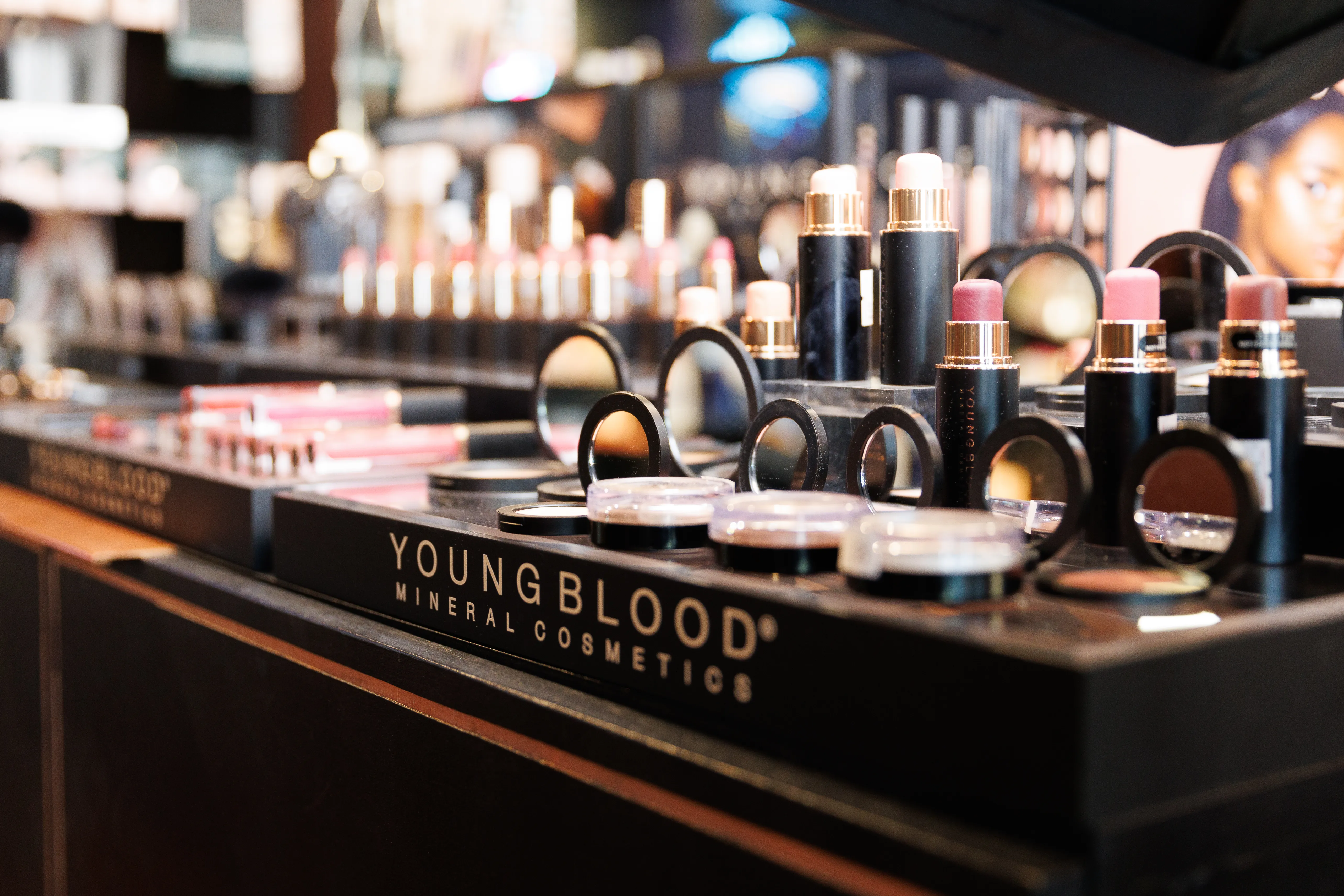 A countertop of Youngblood Cosmetics makeup and lipstick